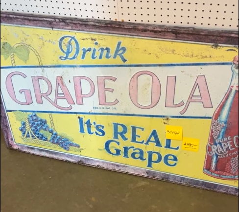 Drink Grape Ola It’s Real Grape SST Embossed Sign