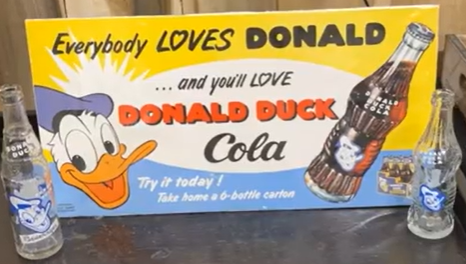 Donald Duck Cola Paper Sign with Two Bottles